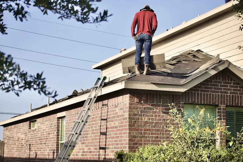 Professional roofer working on a residential roof in Laurel Park